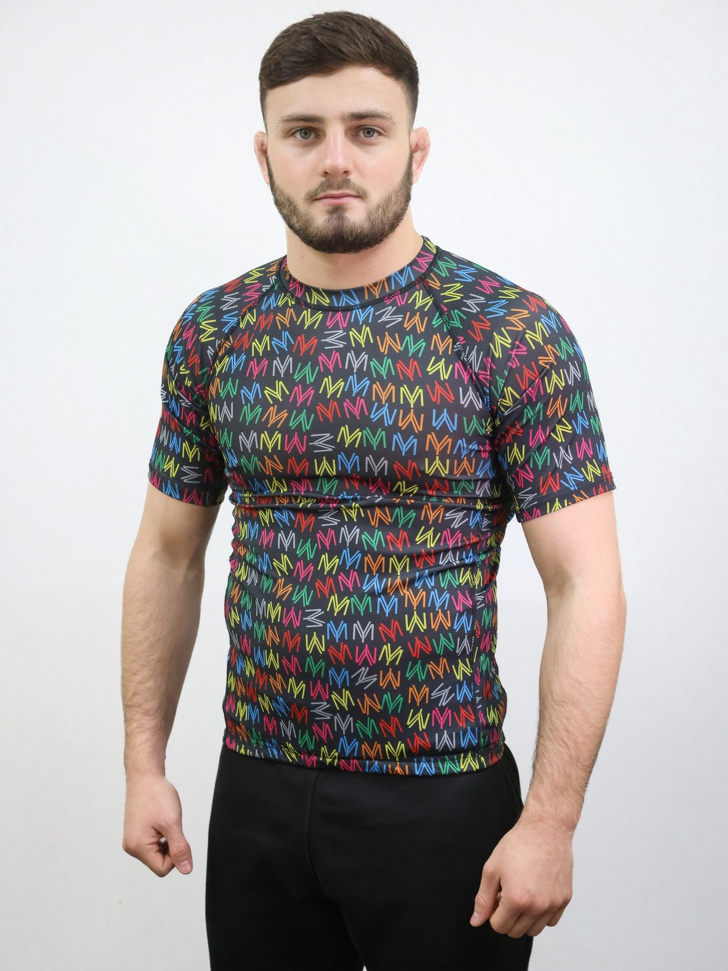 Black rash guard featuring the young money logo all over in illuminous multicolours on a male model size medium