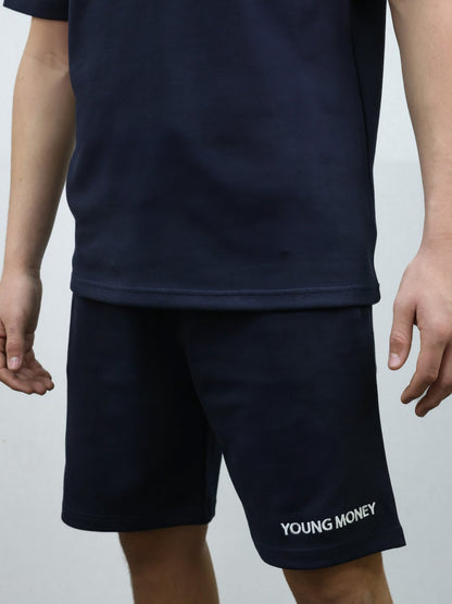 Navy relaxed fit shorts with embroidered young money text on a male model with matching T-shirt set size medium