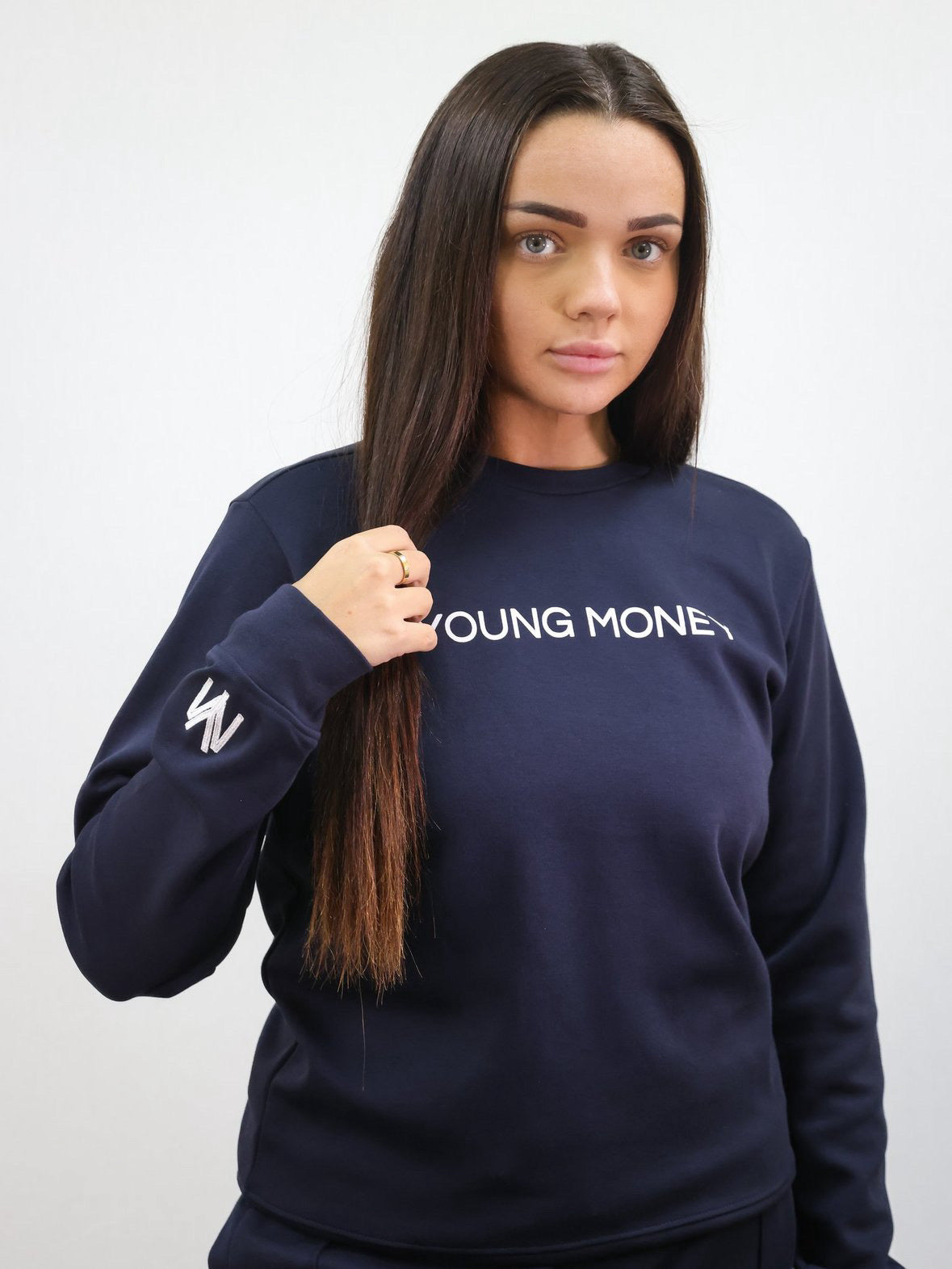 Slim-fit sweatshirt in navy with a printed Young Money across the front and white embroidered YM logo on the sleeve on a female model size small