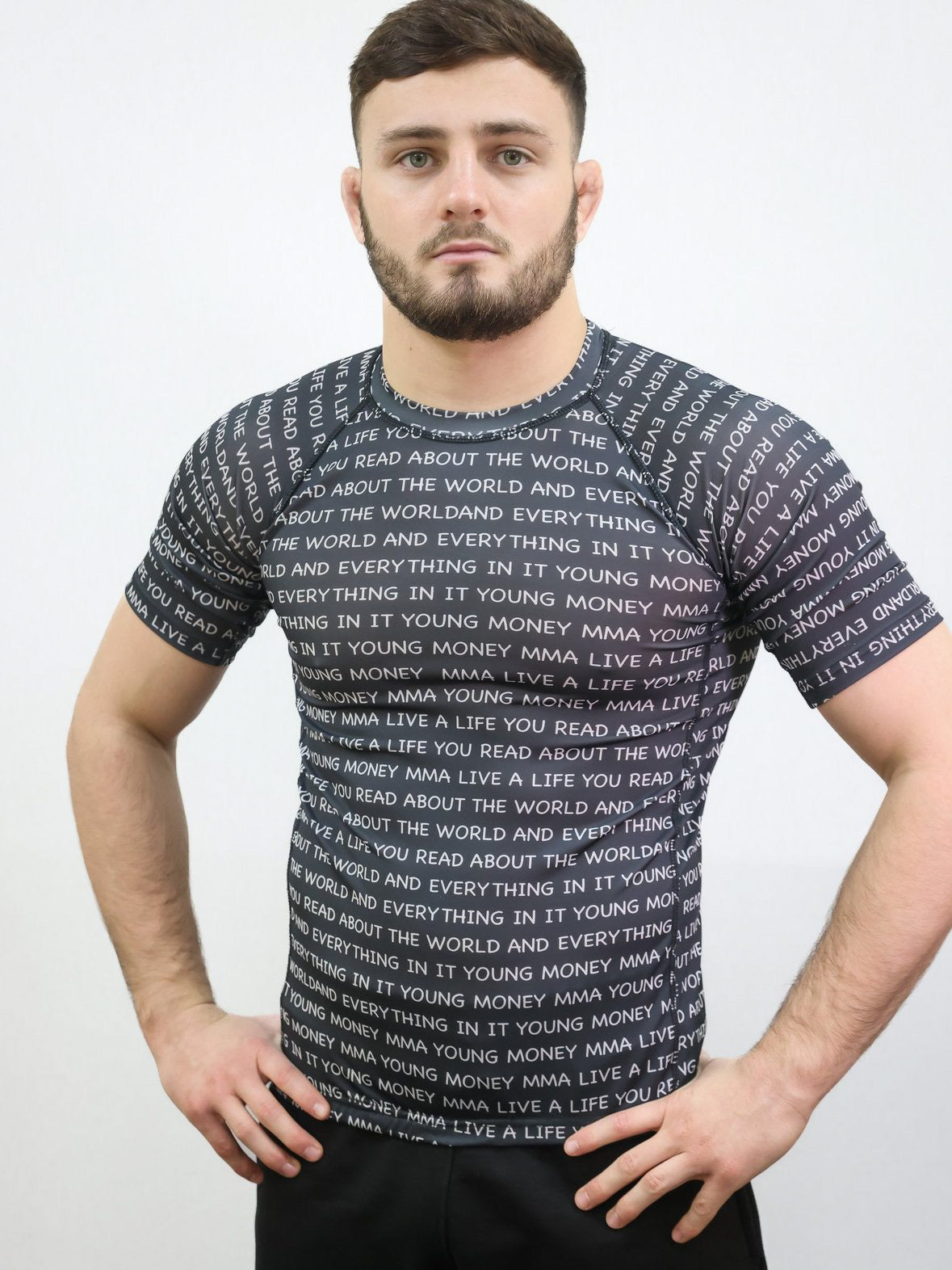 Black rash guard with white slogan text on a male model size medium