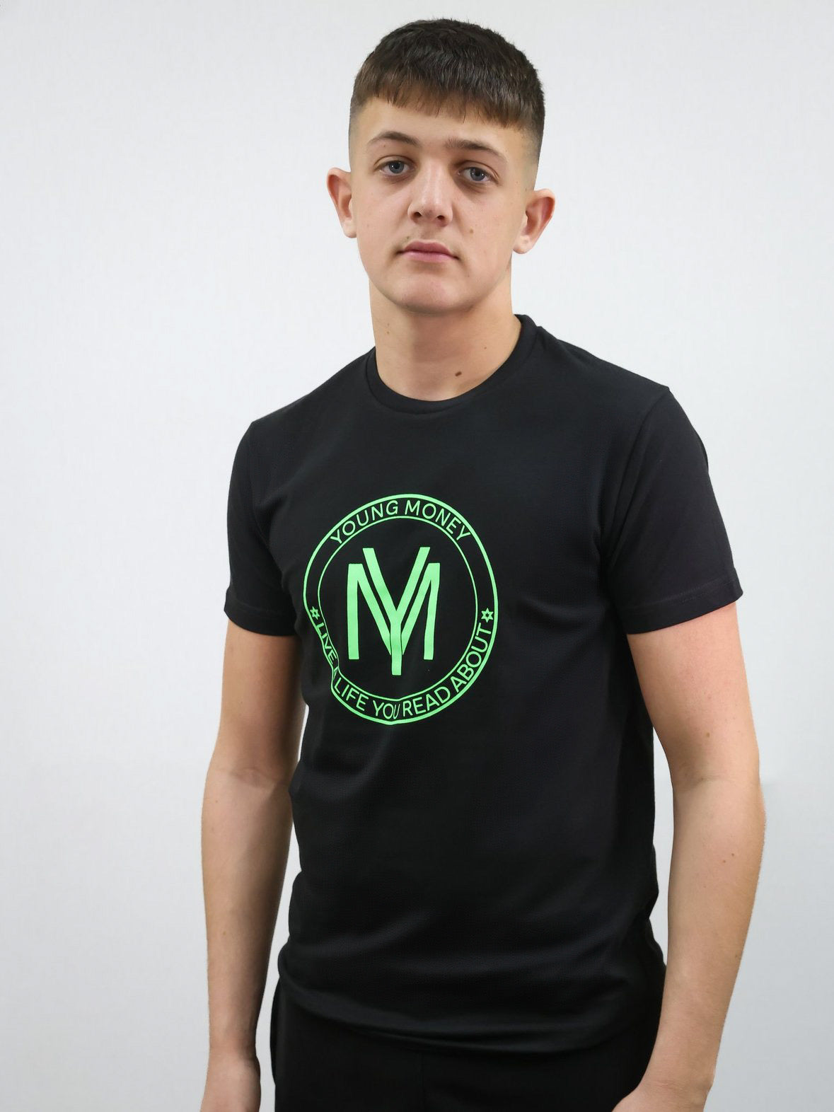 Black slim-fit T-shirt with a coloured shield design across the front with the brand's slogan in green on a male model size medium