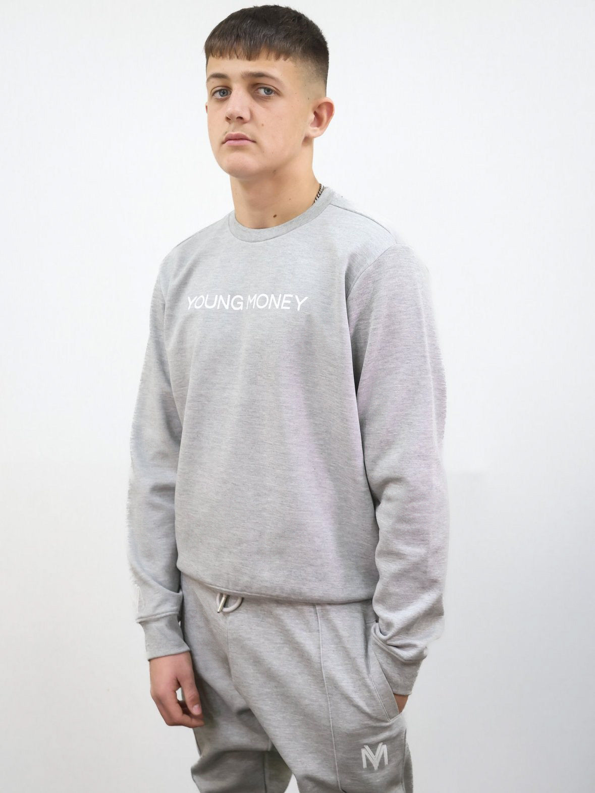 Slim fit tracksuit in grey featuring the sweatshirt and joggers on a male model size medium