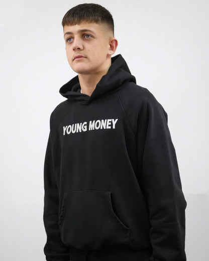 Black organic cotton oversized hoodie with white embroidered young money lettering on the front on a male model size small 