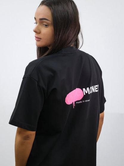 Black organic cotton oversized T-shirt with a pink spray paint graphic on the back on a female model size XS